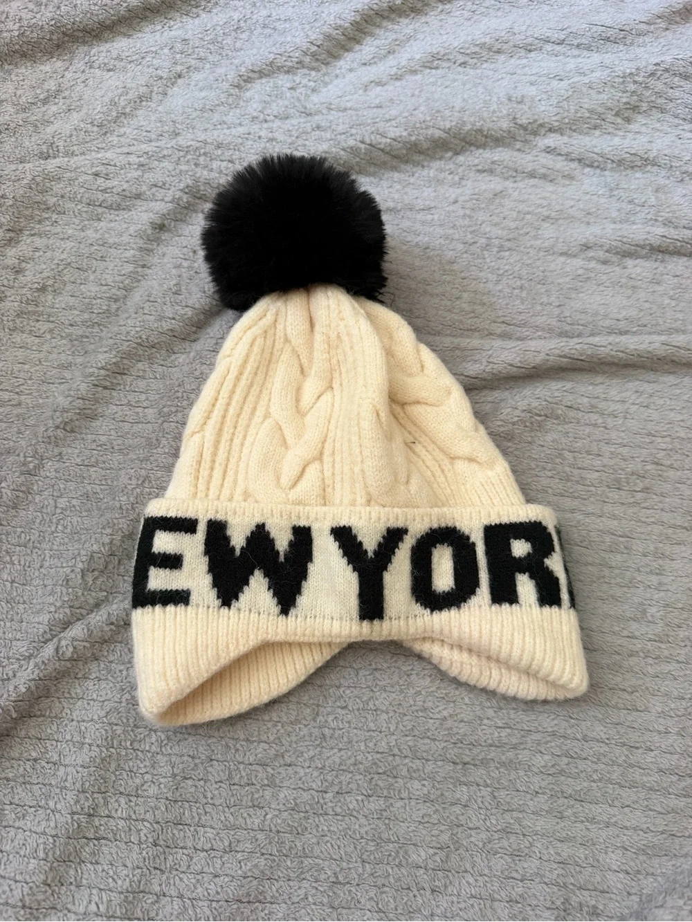 Robin Ruth Cream Cable Knit Pom Beanie with Black Lettering